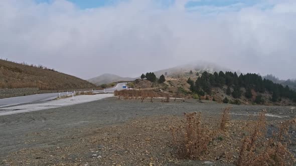 Panoramic View of Mountain Pass Road in Greece and Valley with Clouds By Forest