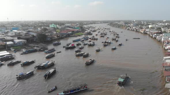 Aerial: flying over Cai Rang floating market on the river, Can Tho, Vietnam