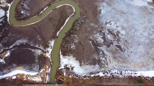 Muddy background with dirty stream. Ecology in danger. Polluted river in dried place. Disappearance 