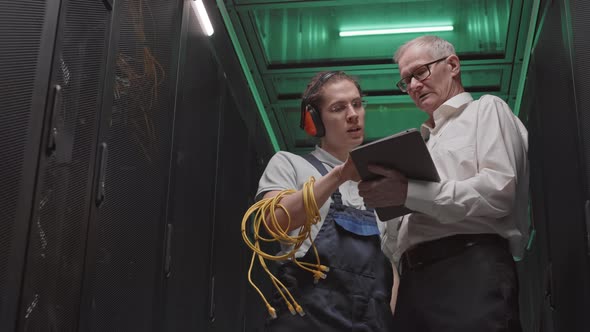Supervisor and Workman Talking in Server Room