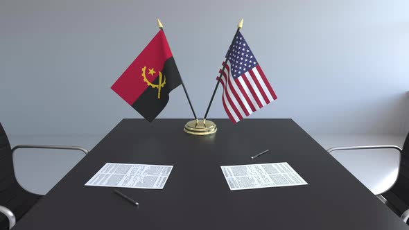 Flags of Angola and the United States on the Table