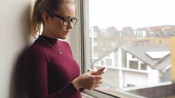 Young woman makinf a call on the phone at home