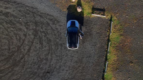 Aerial of a Car and Couple of Tourists on a Little View Point in Iceland