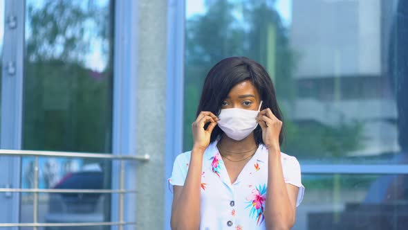 African American Girl Removes a Medical Mask