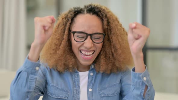 Portrait of Excited African Woman Celebrating Success