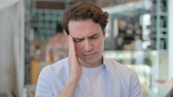 Portrait of Young Man Having Headache