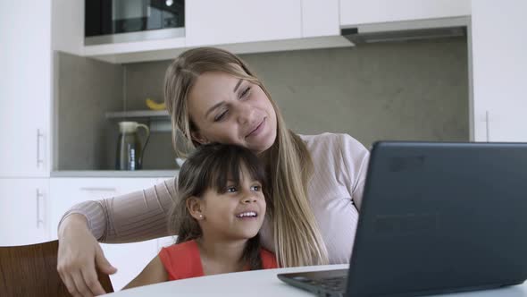 Cute Little Girl and Her Mom Watching Content