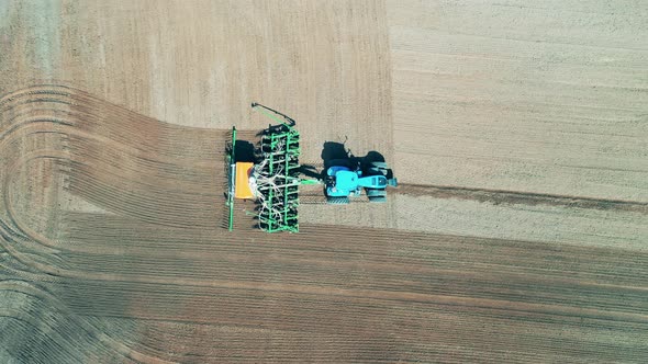 Farming Vehicle Is Seeding the Ground in a Top View