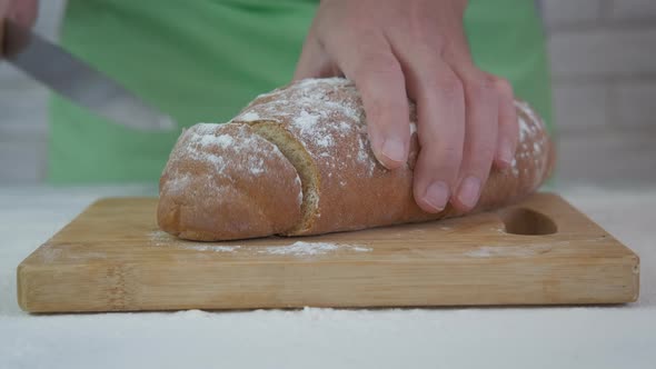 Cut a loaf with knife. 