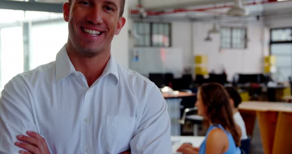 Portrait of smiling business executive with arms crossed