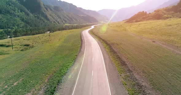 Flight Over Mountain Asphalt Highway Road and Meadow