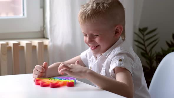 Child Play with Pop It Sensory Toy