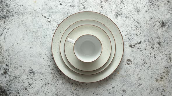 Tableware Set of Ceramic on a Rustic White Background. With Differen Size Plates, Saucer and Cup