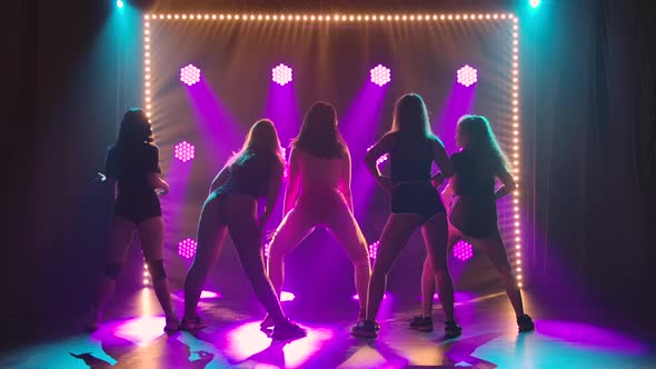 Rear View of a Group of Seductive Dancers Shaking Their Butts in Short Shorts