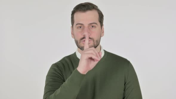 Portrait of Man Putting Finger on Lips Silence White Screen