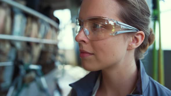 Livestock Farmer Check Milking Automatic Process in Protective Glasses Closeup