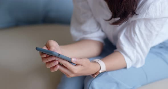 Close up Of Woman Use of Mobile Phone and Sit on Couch