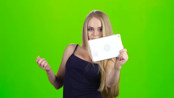 Blonde Girl Makes Various Photos Using Camera of Tablet Pc