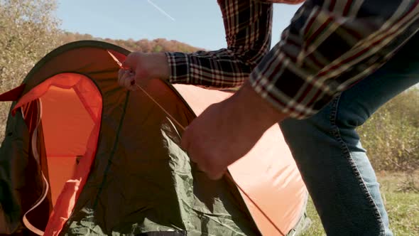 Close Up View of Man Checking the Camping Tent