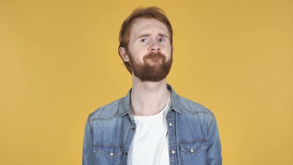 Redhead Man Shaking Head to Reject Yellow Background