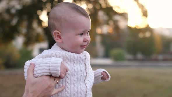 Baby Walking in the Park with Father