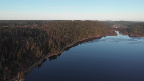 Road Along Shoreline Freshwater and Boreal Forest in National Park Aerial