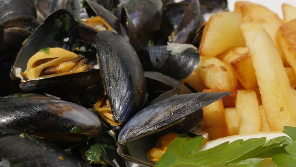 French fries and blue common mussels with   lemon close-up  4K 2160p 30fps UltraHD footage - Tasty p