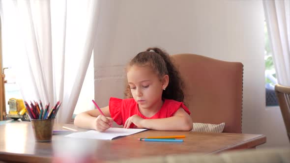 Happy Little Girl or Cute Primary Child School Child of 7-8 Years Old at Home Relaxing Sits in House