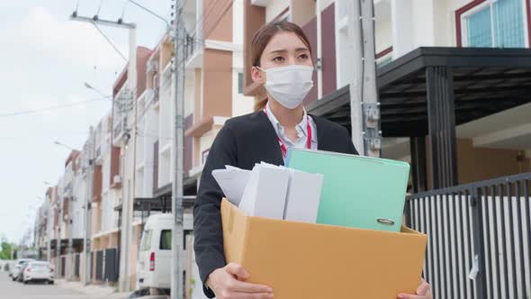 Asian business woman wear face mask after unemployment from company.