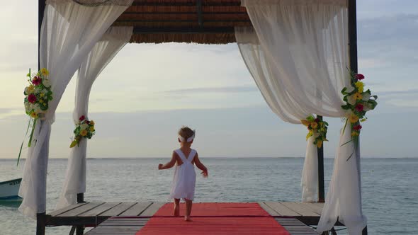 Little Beautiful Girl in White Dress Running at the Holiday