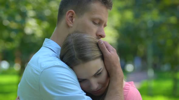 Handsome Man Hugging His Beloved Girlfriend, Calming and Comforting, Close-Up