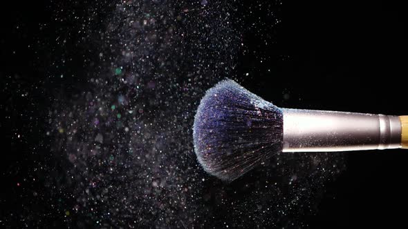 Make Up Brush with Colored Blue Powderon at Black Background Slow Motion