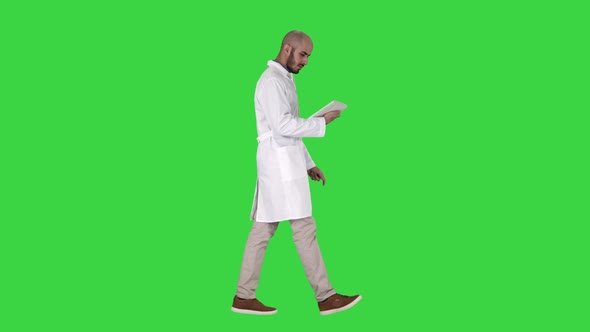 Doctor Checking His Tablet Walking on a Green Screen