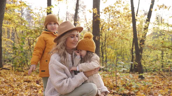 Blonde Adult Woman with Children in Autumn Forest