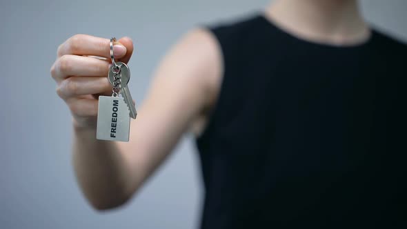 Freedom Word on Keychain in Female Hand, Women Rights, Independent Choice