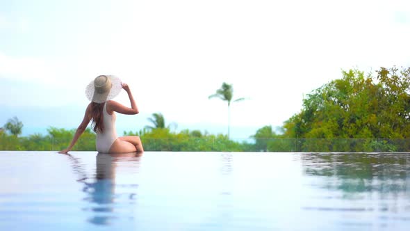 Young asian woman enjoy around outdoor swimming pool for leisure