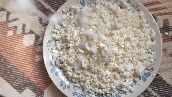 Cottage Cheese Pours in a Bowl in Slow Motion
