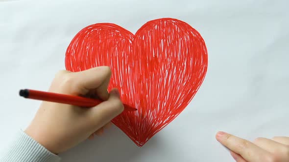 Little Kid Drawing Big Red Heart and Making Word Love of Cubes, Kindness, Peace