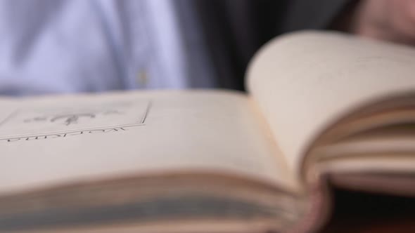 A man looks over some old historical books in a library in Belfast. Content relating to America and