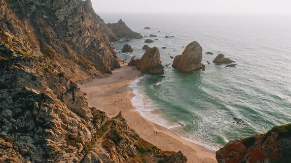 Aerial Drone View of Praia Da Ursa Beach in Sintra Portugal in Sunset Golden Hour Light