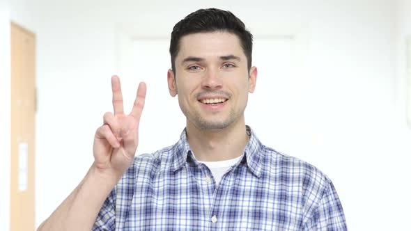 Victory Sign By Young Man