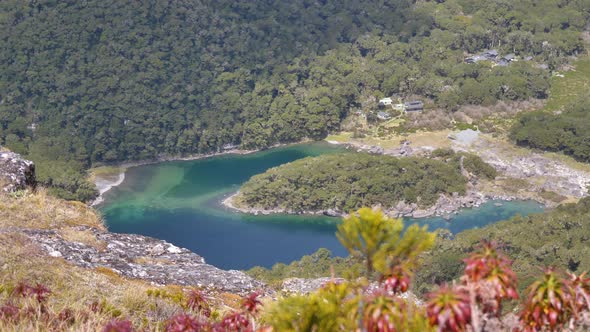 Slider, revealing Lake McKenzie hut in the valley below, Routeburn Track New Zealand