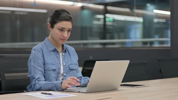 Indian Woman Closing Laptop Going Away in Office