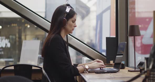 Side View of Caucasian Woman Working in a Coffee Shop