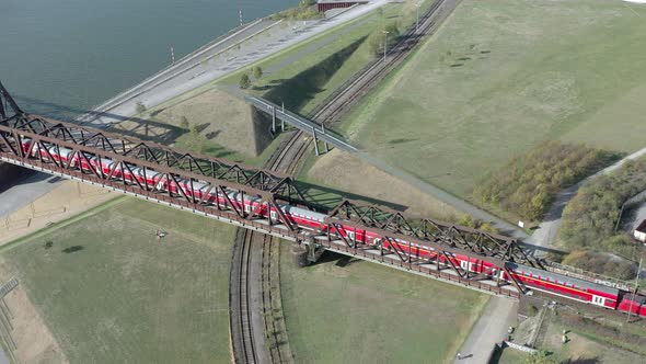 Commuter Train Passing Over an Old Iron Bridge