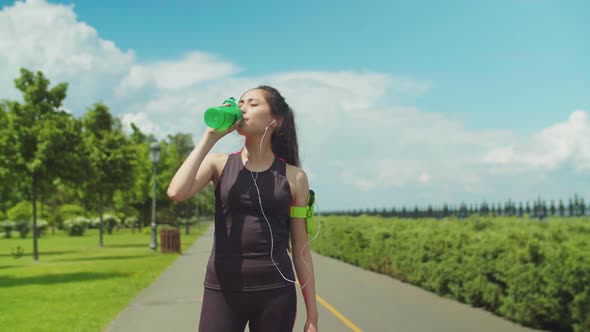 Thitsty Woman Having Energy Drink During Workout