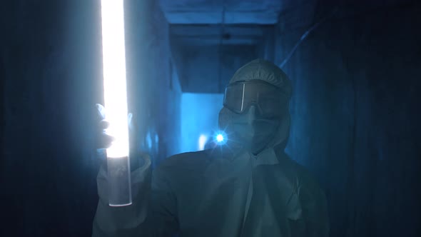 Quarantine Worker Using a Light Stick To Examine the Space Around Them.