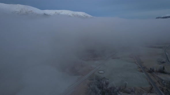 Flying over a foggy covered fields in Northern Norway (Scandinavia), Helgeland, Blåfjelldalen, Flyov