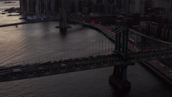 High Angle View of Slowly Moving Vehicles on Large Suspension Bridge Over River