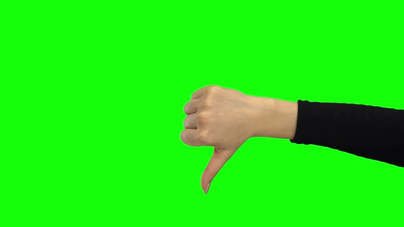 Hand of Girl Showing Thumb Down. Green Screen. Close Up